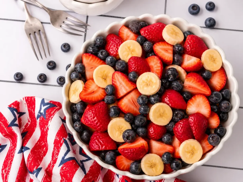 4th of July Fruit Salad with strawberries blueberries and bananas in a bowl
