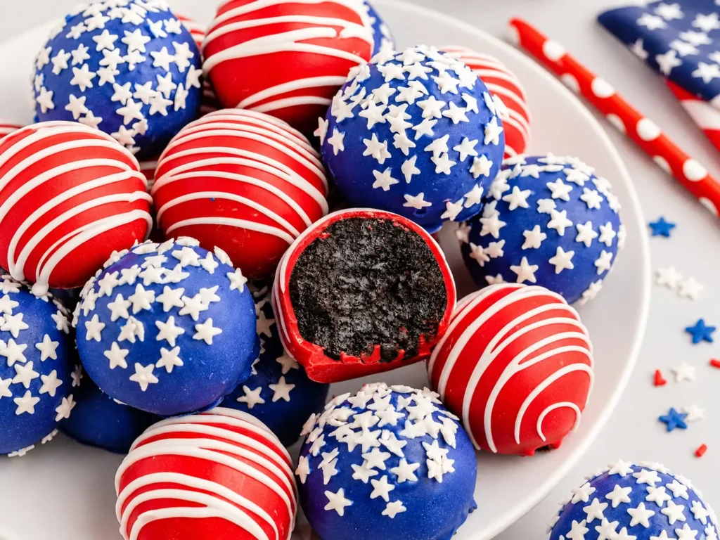 4th of July Oreo Balls coated in red and blue candy with white drizzle and star sprinkles