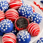 4th of July Oreo Balls coated in red and blue candy with white drizzle and star sprinkles