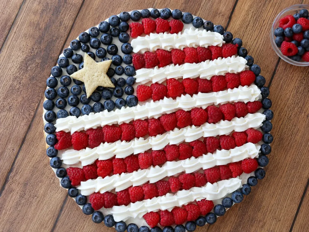 American Flag Fruit Pizza topped with fresh berries and cream cheese mousse