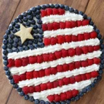 American Flag Fruit Pizza topped with fresh berries and cream cheese mousse