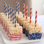 American Flag Rice Krispie treats decorated with red white and blue candy melts