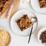 Freshly baked Banana Oatmeal Bars with chocolate chips on a cooling rack