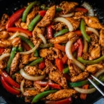 Black Pepper Chicken served with peppers and onions in glossy sauce