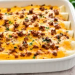 Cheesy Breakfast Enchiladas with eggs, bacon, and sausage fresh from the oven