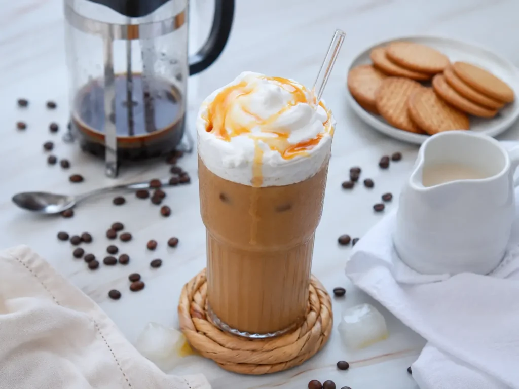Creamy caramel iced coffee topped with whipped cream and caramel drizzle