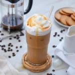 Creamy caramel iced coffee topped with whipped cream and caramel drizzle