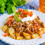 Cheesy Taco Potatoes topped with taco beef and melted cheese