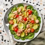 Chickpea Tuna Salad with feta, cucumber, tomatoes, and fresh dill in a serving bowl