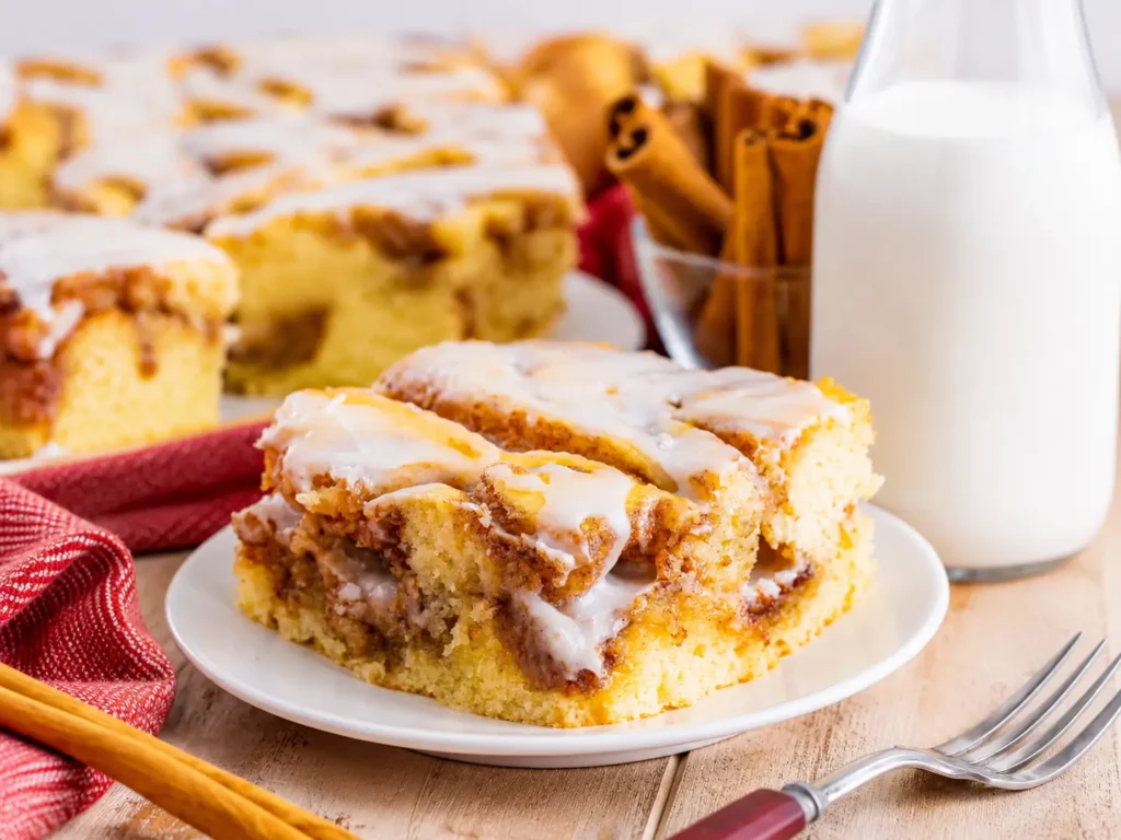 Warm Cinnamon Roll Cake with vanilla glaze and cinnamon swirls