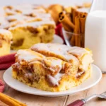 Warm Cinnamon Roll Cake with vanilla glaze and cinnamon swirls