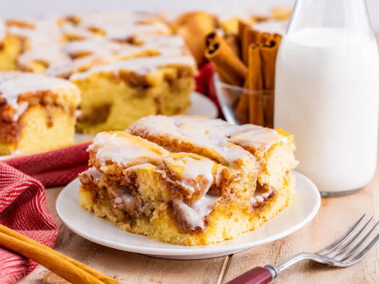 Warm Cinnamon Roll Cake with vanilla glaze and cinnamon swirls