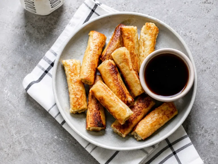 Golden French Toast Roll-Ups served warm with syrup on a breakfast plate