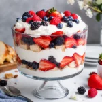 Fresh Berry Trifle layered with whipped cream, cake, and fresh berries in glass bowl