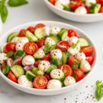 Fresh Cucumber Caprese Salad with tomatoes and mozzarella in a bowl