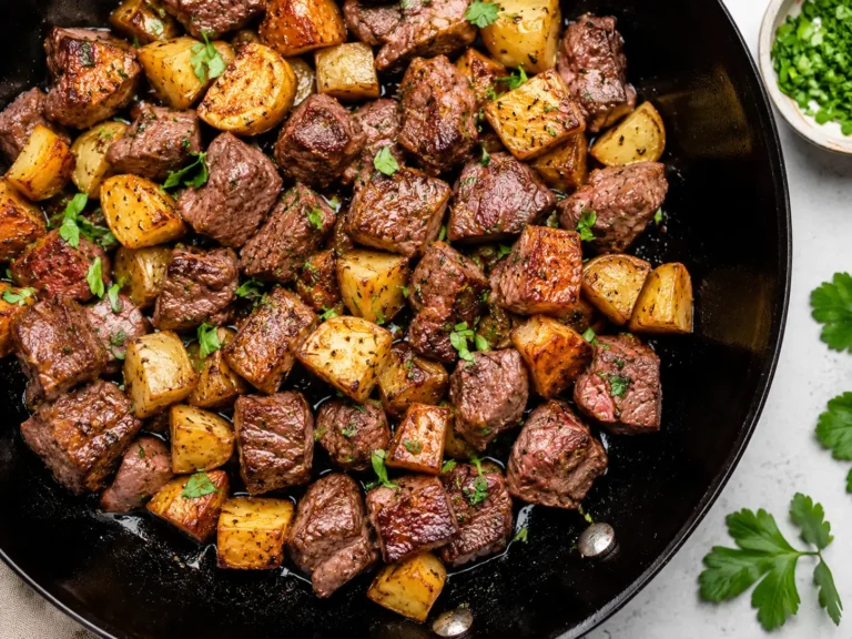Garlic Butter Steak Bites and Potatoes served in a cast iron skillet