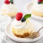 Mini Cheesecake Cups topped with whipped cream and fresh berries