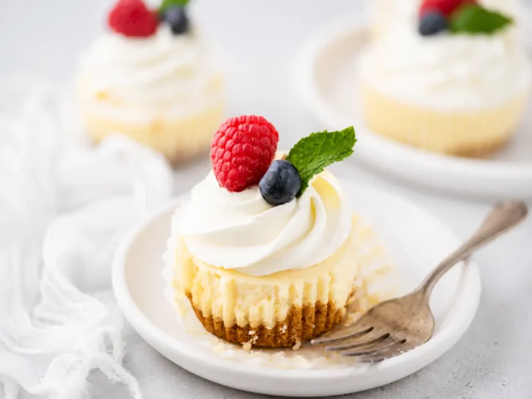 Mini Cheesecake Cups topped with whipped cream and fresh berries