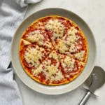 Crispy cheesy Pizza Eggs served hot in a skillet with herbs