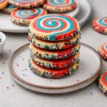 Freshly baked Red, White, and Blue Pinwheel Cookies on a festive dessert platter