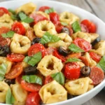Roasted Red Pepper Tortellini Salad served cold with basil and parmesan