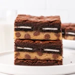 Thick homemade Slutty Brownies with Oreo and cookie dough layers
