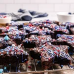 Star-Spangled Brownies topped with blue candy drizzle and patriotic sprinkles