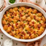 Tater Tot Breakfast casserole with eggs, bacon, sausage, and melted cheese