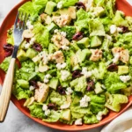 Avocado Tuna Salad served in a bowl with feta, cucumber, olives, and toasted almonds
