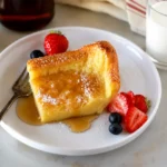 Freshly baked German Pancakes with golden puffed edges and powdered sugar