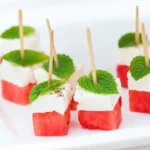 Watermelon Feta Skewers with mint and feta on a summer platter